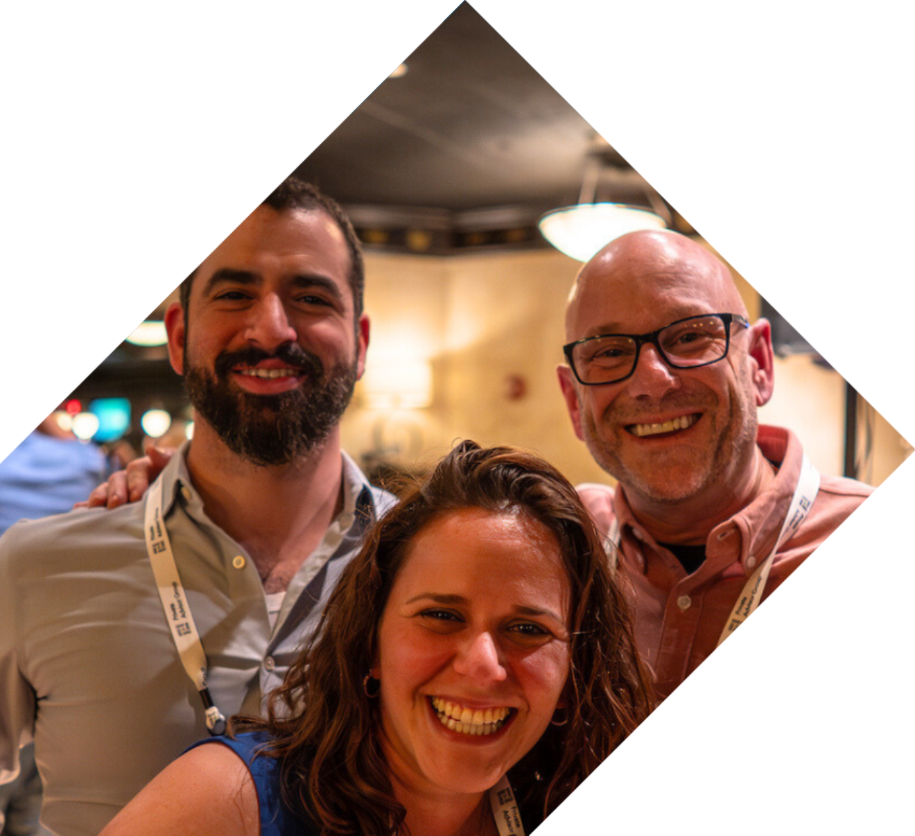 Three smiling individuals in a square frame, representing the supportive community of Your Journey Private Advisor Group.